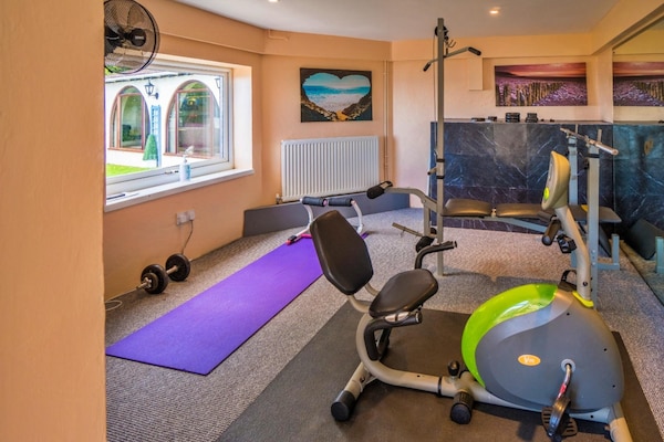 Foto van Landhuis met uitzicht op de oceaan en jacuzzi - Vakantiehuis in Torquay - gym
